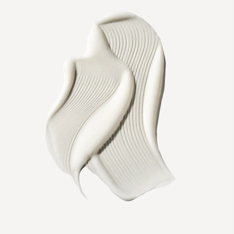 A thick, creamy off-white drop of Olaplex moisturizer and leave-in conditioner sample presented on a clean, light off-white background.