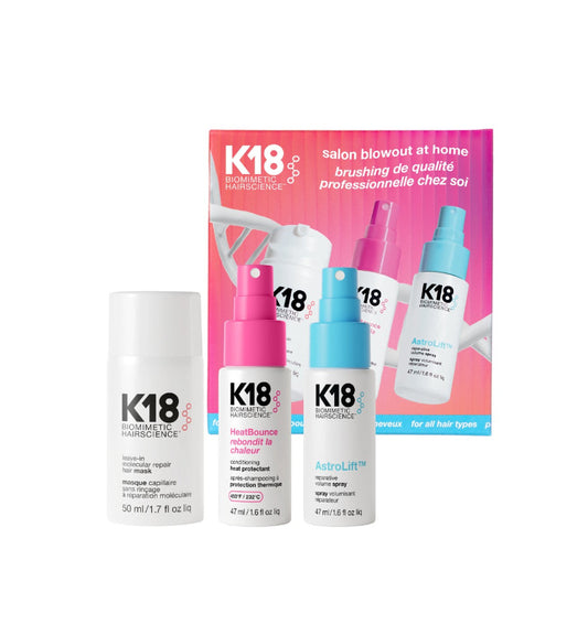 K18 Biomett Hairscience salon blowout at home kit containing three bottles (Hairpower Repair, Heat Bomb, AstroLift) in front of a pink and blue product box on a white background.