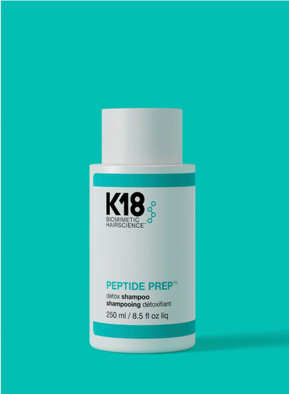 A bottle of K18 Biometric Hairscience Peptide Prep Detox Shampoo, 250 ml, shown against a solid teal background.