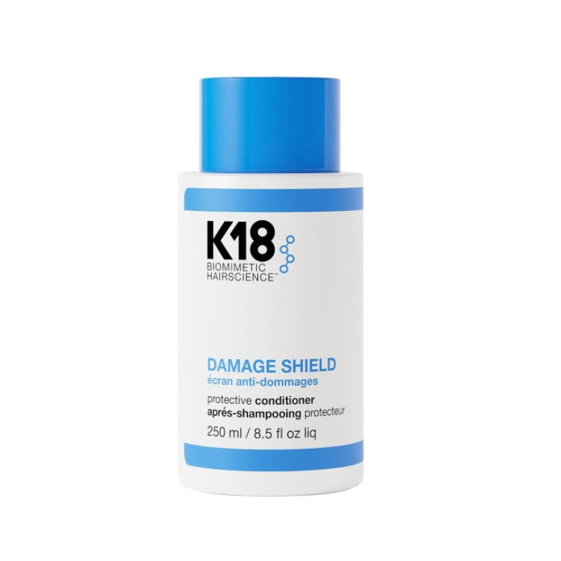 K18 Biometric Hairscience Damage Shield Protective Conditioner in a white bottle with a blue cap and blue accents on the label.