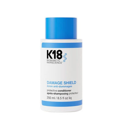 K18 Biometric Hairscience Damage Shield Protective Conditioner in a white bottle with a blue cap and blue accents on the label.
