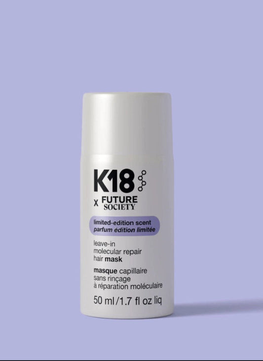 A white cylindrical bottle of K18 x Future Society leave-in molecular repair hair mask 50 ml, set against a solid lavender background.