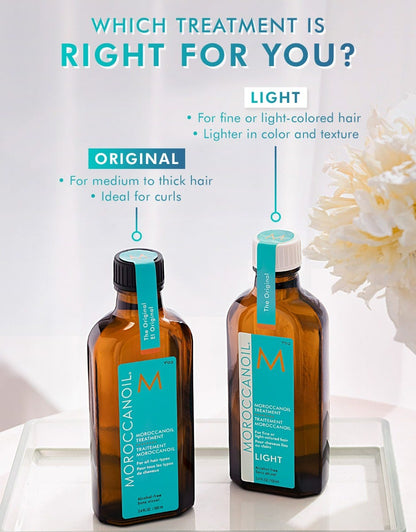 Two bottles of Moroccanoil hair treatment with product descriptions on a light background.