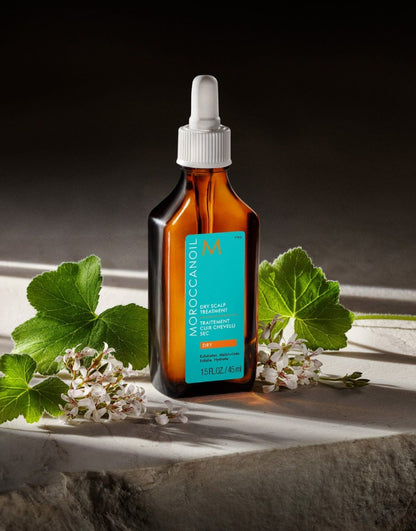 Moroccanoil hair oil bottle with dropper on a dark background