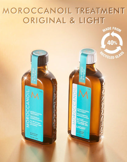 Two bottles of Moroccanoil treatment on a beige background with recycling information.