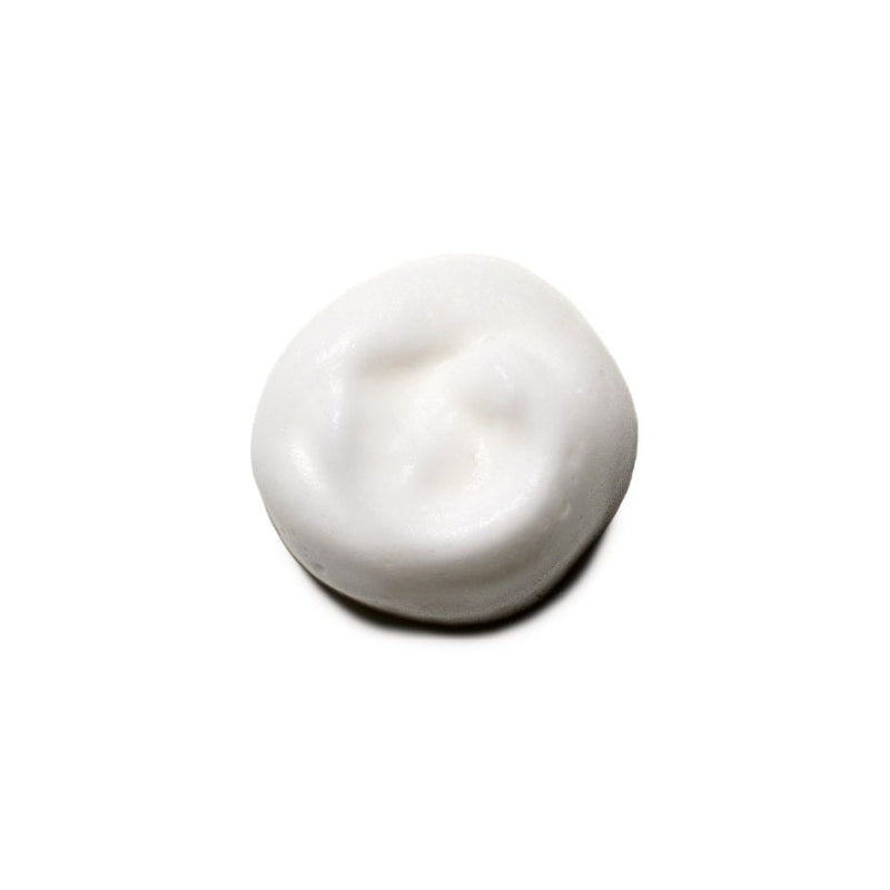 White cream sample  of Moroccanoil volumizing mousse on a white background