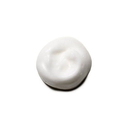 White cream sample  of Moroccanoil volumizing mousse on a white background