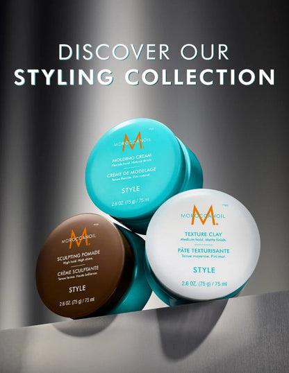 Three hair styling products from Moroccano Oil are arranged on a reflective dark surface with large text reading 'DISCOVER OUR STYLING COLLECTION' above them. The products are a turquoise molding cream, a brown sculpting pomade, and a white texture clay, each with the Moroccano Oil 'M' logo visible on the lids.