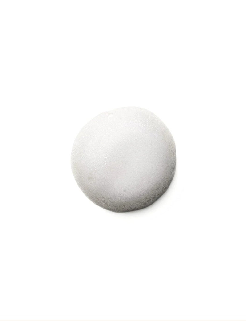 A single white foam bubble  from Moroccanoil curl control mousse photographed on a plain white background