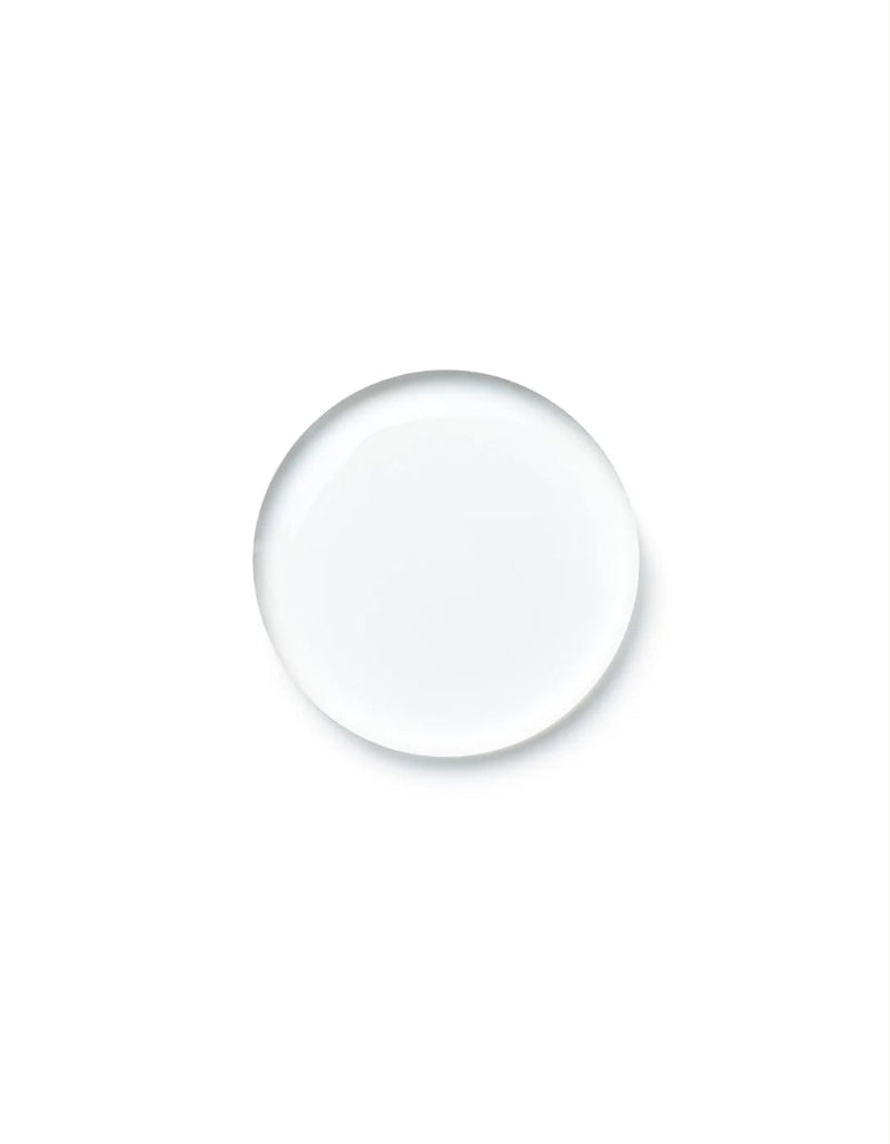 A single clear, round glass droplet or bubble centered on a solid white background.
