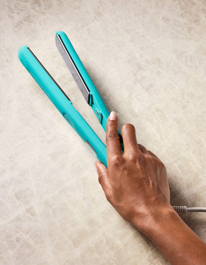 Moroccanoil perfectly finish flat iron holding by a person 