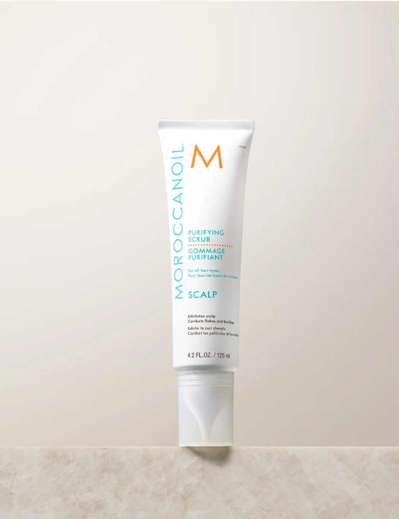 A tube of Moroccanoil pre-wash scalp treatement 125 ml on a beige background