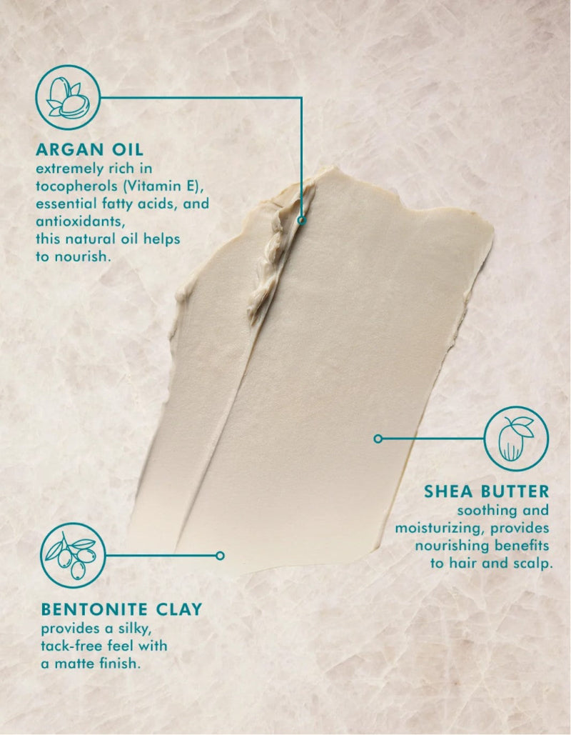 A textured beige cosmetic smear on a light beige background with callout text and icons identifying ingredients: argan oil, shea butter, and bentonite clay. This smear belongs to Moroccanoil texture clay