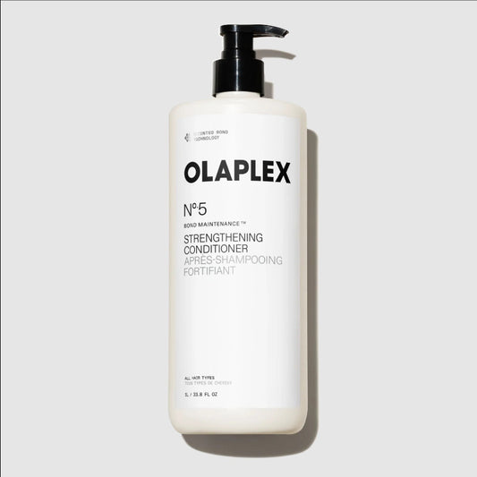 A large white bottle of liter size Olaplex No. 5 Bond Maintenance Strengthening Conditioner with a black pump dispenser, set against a light gray background.