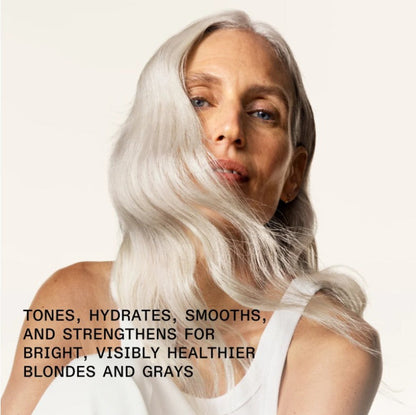Woman with white silver blond hair against a white background with text about hair care to strengthen for healthier blondes and grays