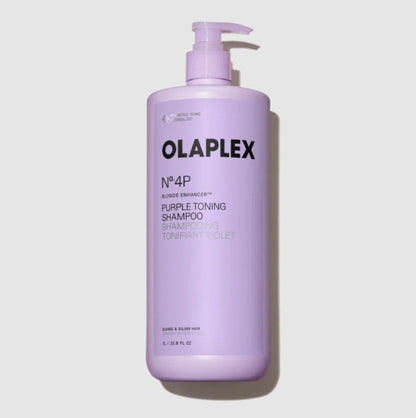 A large bottle of OLAPLEX No.4P Purple Toning Shampoo in a lavender purple color, featuring a matching pump dispenser, set against a light gray background with a soft shadow.