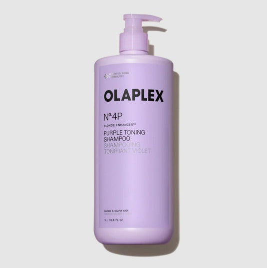 A large bottle of OLAPLEX No.4P Purple Toning Shampoo in a lavender purple color, featuring a matching pump dispenser, set against a light gray background with a soft shadow.
