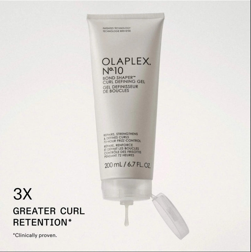 A white squeeze tube of Olaplex No. 10 Bond Shaper Curl Defining Gel with its cap off, displayed on a light gray background with promotional text reading '3X GREATER CURL RETENTION'.
