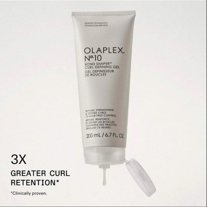 A white squeeze tube of Olaplex No. 10 Bond Shaper Curl Defining Gel with its cap off, displayed on a light gray background with promotional text reading '3X GREATER CURL RETENTION'.