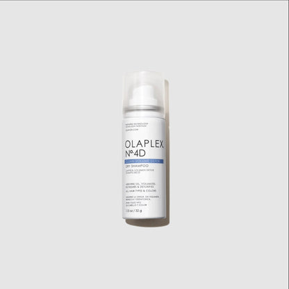 A mini travel bottle of Olaplex No.4D Light Shampoo with a clear cap, standing upright against a light gray background.