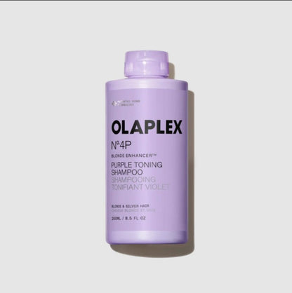 A bottle of Olaplex No.4P Purple Toning Shampoo 8.5 oz in a light lavender purple color, shown on a light gray background with a soft shadow.