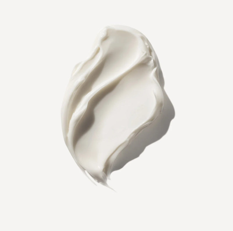 A textured smear of thick, creamy off-white cosmetic cream-Olaplex rich hydrating mask on a clean, solid off-white background.