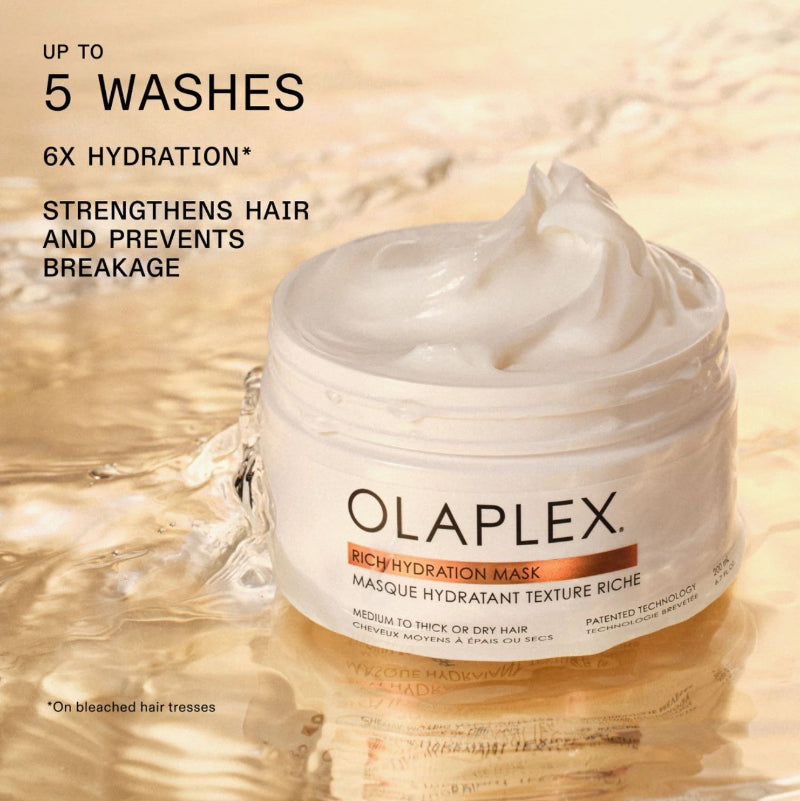 Olaplex Rich Hydration Mask in a white jar with a white whipped cream product, set against a warm, golden water-textured background  showing 6 times more hydration 