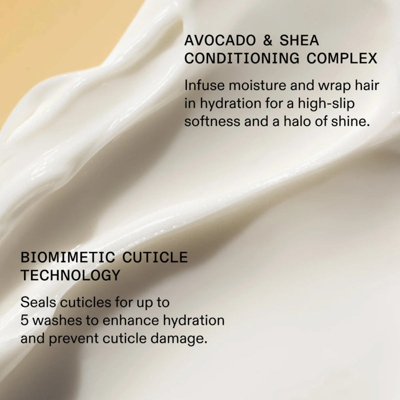Close-up of a creamy texture with text about avocado and shea conditioning complex and biomimetic cuticle technology.