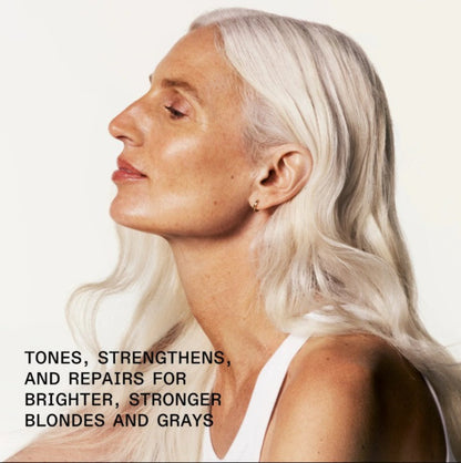 Woman with white hair against a plain background with text about tone, strengthen and repair hair