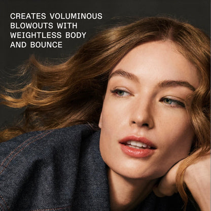Woman with voluminous hair against a dark background with text about hair product benefits. She used Olaplex volumizing hair mist for best results