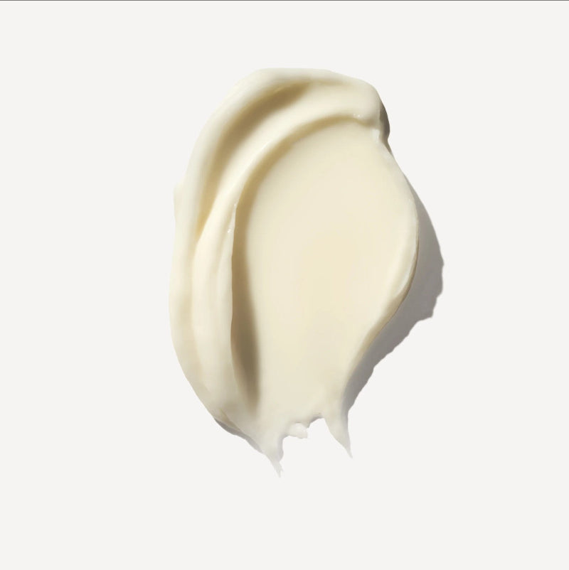 A dollop of creamy off-white buttery Olaplex nourishing hair mask with soft ridges and a subtle shadow, centered on a light gray background.