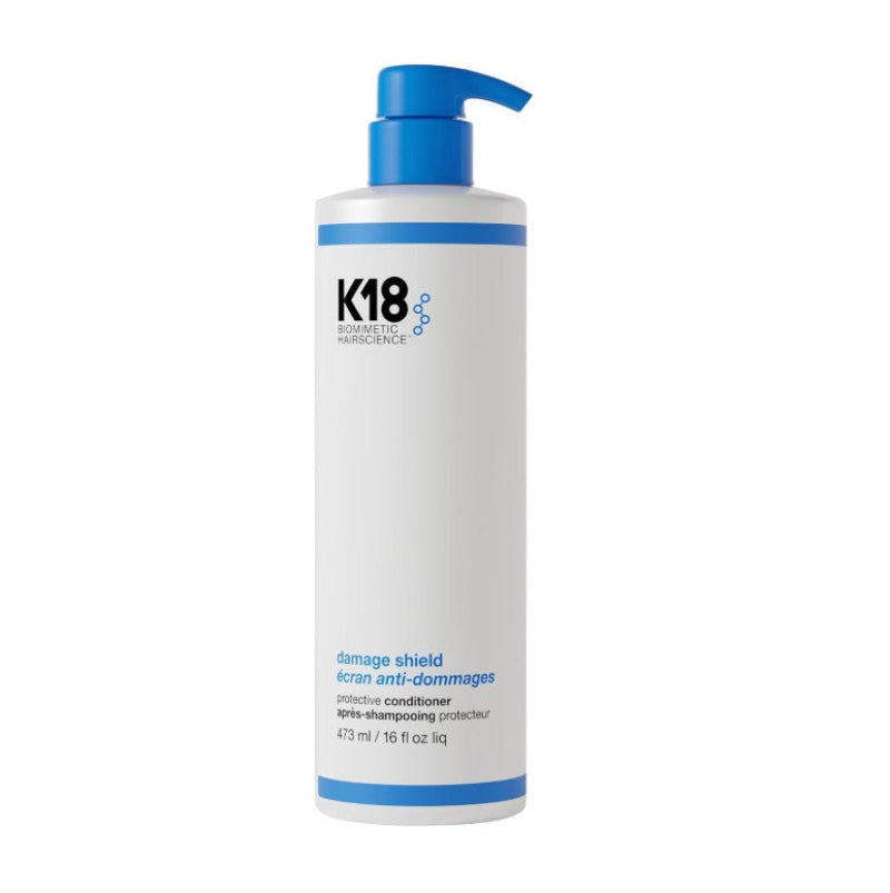 K18 Damage Shield Keratin Anti-Damages Protective Conditioner in a 473 ml white bottle with a blue pump dispenser, shown on a plain white background.